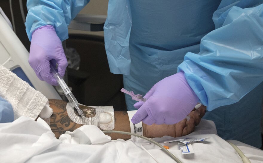 A nurse injects steroids into a COVID-19 patient on Monday, Aug. 2, 2021. (AP Photo/Ted Jackson)