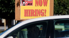 A car drives by a "now hiring" sign that is posted outside of the soon-to-be-open Marin Ace Hardware store on Nov. 30, 2011 in San Rafael, California.