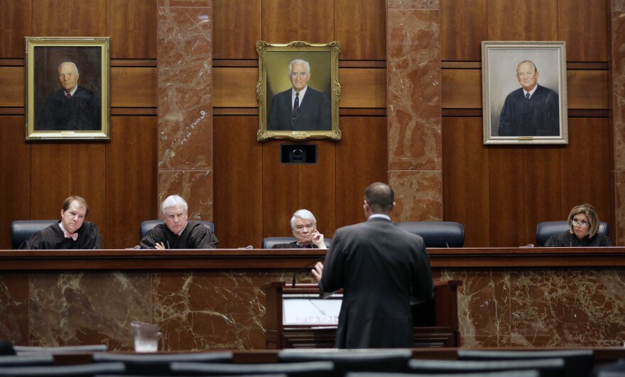 Texas Supreme Court justices, from left, Don Willett, Paul Green, Nathan Hecht, and Eva Guzman listen as attorney Chad Baruch argues in a case for a home-schooling family in El Paso accused of failing to teach its kids anything because they were waiting for the second coming of Jesus Christ, Monday, Nov. 2, 2015, in Austin, Texas.