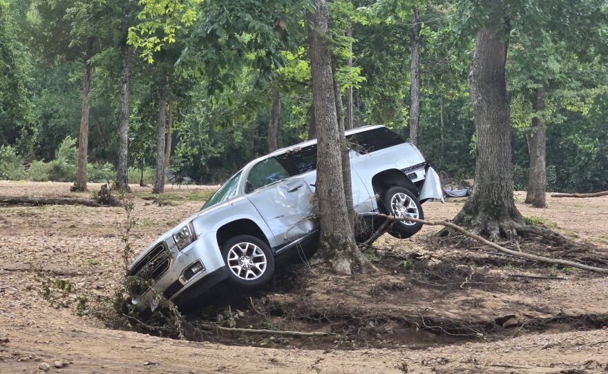 A car forced against a tree after the July 10 flash flood at Riversedge Campground.