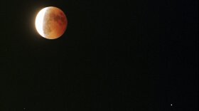 The planet Saturn can be seen diagonally to the right of the moon during a total lunar eclipse seen from Emeryville, Calif., Thursday, September 26, 1996.