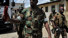 Ibrahim Coulibaly walks in the Abobo neighborhood of Abidjan on Tuesday. Coulibaly says he's the head of a militia called the Invisible Commando. The group fought against former President Laurent Gbagbo's forces, but has not joined the newly renamed army, the Republican Forces of Ivory Coast.