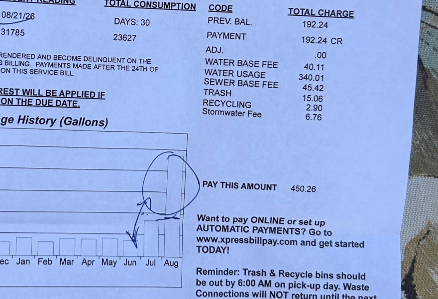 A water bill showing a bar graph with most months at a pretty low bar and then August being a much larger bar. On the side it says "Pay This Amount 450.26" It also shows his previous balance of 192.24.