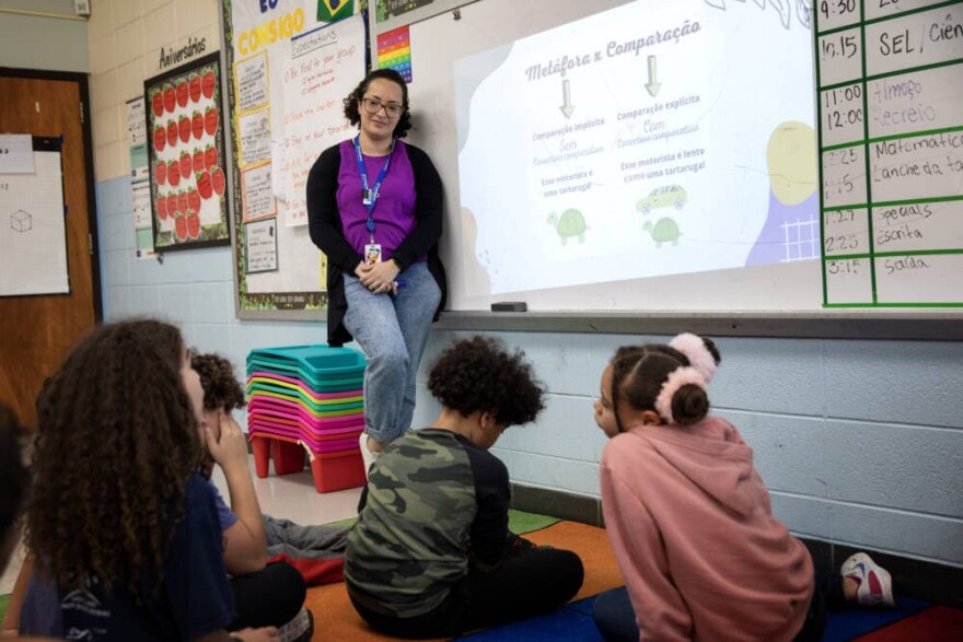 Bilingual teacher Juliana Santos listens to a student in her classroom at Potter Road Elementary School, Framingham.