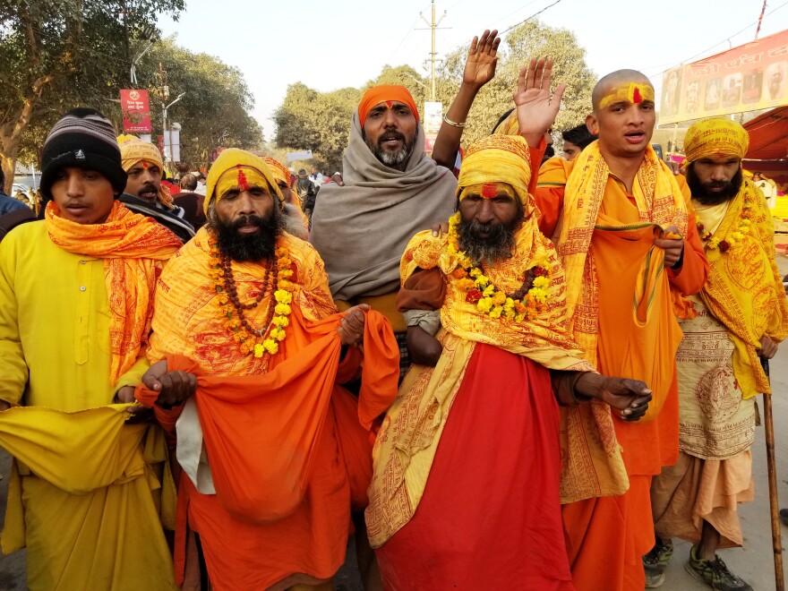 Hindu priests draped in orange sarongs and garlands of marigolds are among the pilgrims.