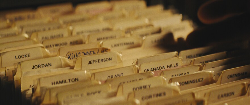 a close up of aged files in a filing cabinet