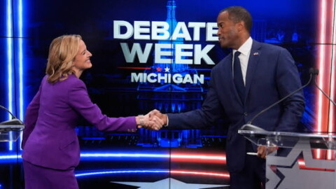 Michigan Secretary of State Jocelyn Benson and U.S. Congressman John James shake hands before gubernatorial debate in Grand Rapids