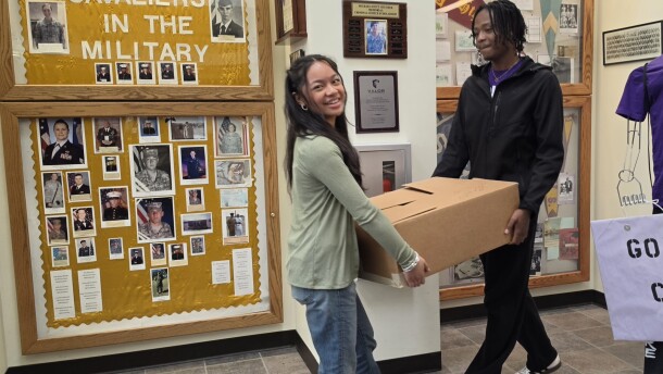 East Stroudsburg High School South students Mia Cabardo and Jahmere Grant carry a box of pants in the school's lobby on Friday. Members of the Key Club sorted 650 pairs of pants to distribute to area clothing closets.