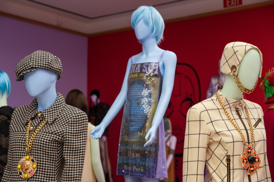 A selection of Anna Sui creations, including a houndstooth suit with a matching cap and a huge gold medallion, and a sequined mini-dress.