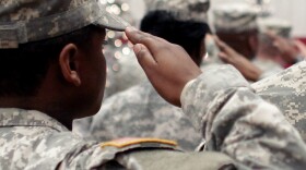 In this Wednesday Dec. 5, 2012, file photo, soldiers salute the U.S. flag during the Pledge of Allegiance at a welcome home ceremony for soldiers returning from a deployment in Afghanistan, at Fort. Carson, Colo. For veterans, the GI Bill can be the ticket to a debt-free college education.