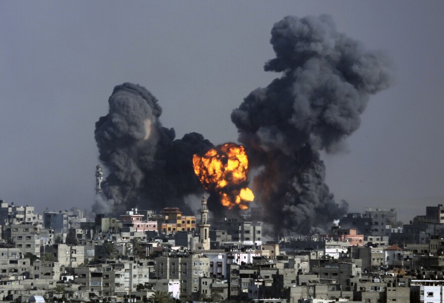 Smoke and fire rises over Gaza City on Tuesday. Israeli airstrikes pummeled a wide range of locations along the coastal area as diplomatic efforts intensified to end the two-week war.