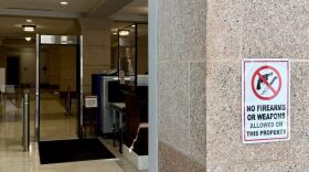 A sign outside of a security checkpoint at the Oklahoma Capitol reads “No firearms or weapons allowed on this property.”