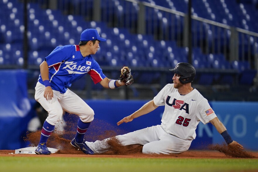 United States' Todd Frazier slides into third base past South Korea's Kyoungmin Hur during a semi-final baseball game at the 2020 Summer Olympics, Thursday, Aug. 5, 2021, in Yokohama, Japan. (AP Photo/Sue Ogrocki)