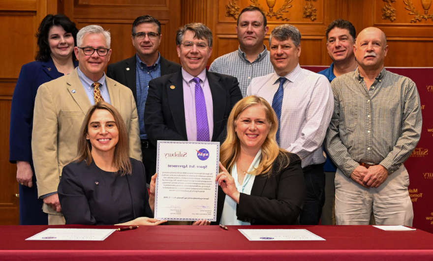 SU President Carolyn Ringer Lepre (front left) and Dr. Makenzie Lystrup (front right) formalized SU's partnership with NASA during a signing ceremony for the Space Act Agreement. Joining them were Dr. Michael Scott, dean of SU's Richard A. Henson School of Science and Technology; Dr. Laurie Couch, SU provost and senior vice president of academic affairs; David Pierce, NASA Wallops Flight Facility director; and Henson School faculty members.