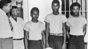 Lake County Sheriff Willis McCall, far left, and an unidentified man stand next to Walter Irvin, Samuel Shepherd and Charles Greenlee, from left, in Florida. The three men along with a fourth were charged with rape in 1949. Florida Gov. Ron DeSantis and a Cabinet granted posthumous pardons Friday, Jan. 11, 2019, to Shepherd, Irvin, Charles Greenlee and Ernest Thomas, the four African-Americans accused of raping a white woman in 1949 in a case now seen as a racial injustice. Relatives of the Groveland Four, as they became known, received restitution totaling $4 million in the 2026-27 Florida budget.