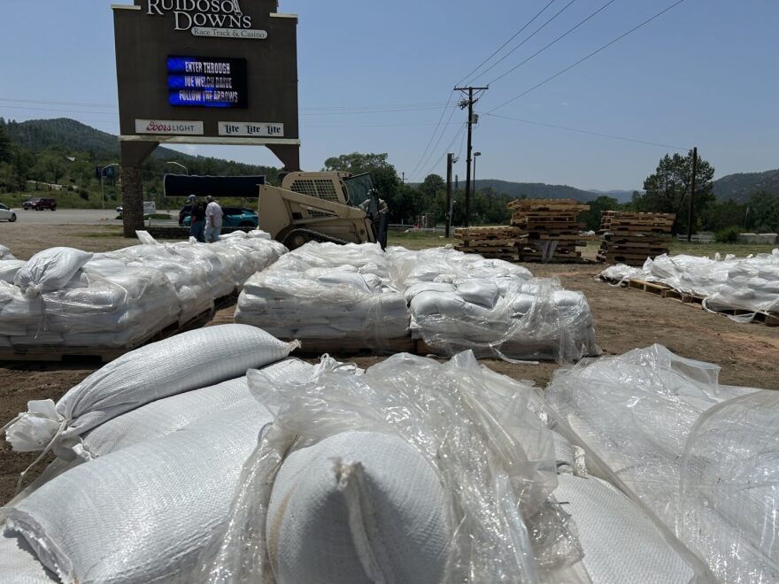 A pile of sandbags sits on a sidewalk in Ruidoso after post-fire flooding wreaked havoc in 2025. The Ruidoso fires and floods constituted a major cause of millions of dollars in emergency spending. Some lawmakers believe the way the governor is paying for emergency response is illegal. (Photo courtesy NMDHSEM)