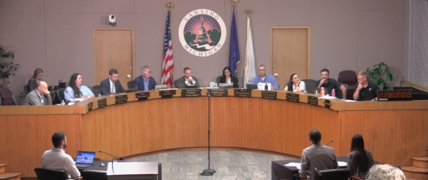 Lansing city council members in a meeting setting.
