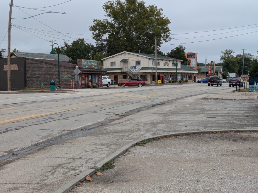 This street is lined with businesses, but the road has seen better days.