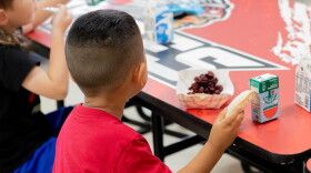 A pre-kindergarten student eats a peanut butter and jelly sandwich during "third meal" at Whitebead Public Schools in Pauls Valley, Okla.