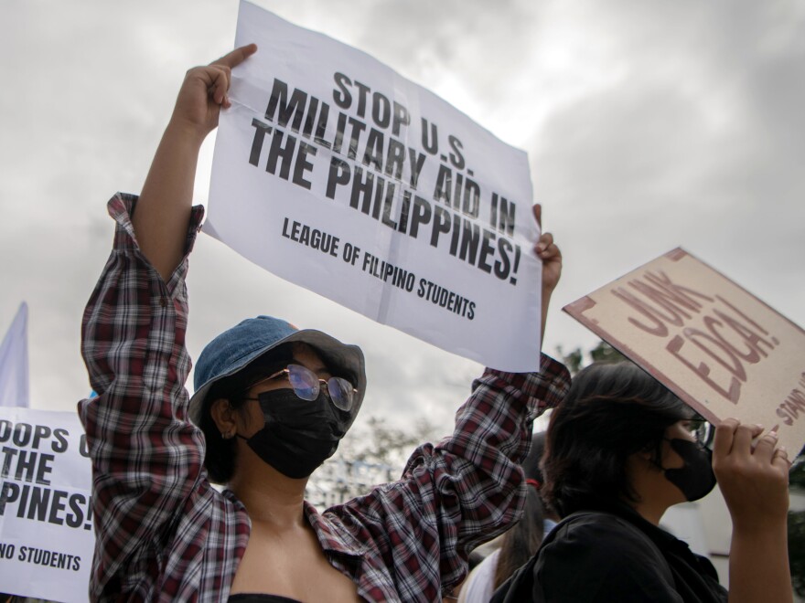 Activists stage a protest outside the gates of Camp Aguinaldo main military camp on Feb. 2, 2023 in Manila.