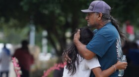 Families hug outside the Willie de Leon Civic Center where grief counseling will be offered in Uvalde, Texas, on May 24, 2022. (Allison Dinner/AFP via Getty Images)