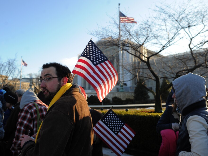 People line up in front of the U.S. Supreme Court on Tuesday before the justices hear arguments in the first of two same-sex marriage cases.