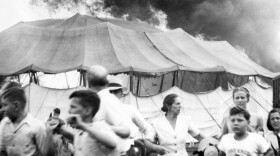 (Original Caption) 7/6/1944-Hartford, CT- Their faces mirroring fear and the panic that sends them running for their lives from the holocaust, these people are shown against a backdrop of roaring flame and smoke, in this unusual photo of the nation's greatest circus tragedy taken as many were screaming their lives out in the fiery pandemonium of the "Big Top"(back). The death toll, late tonight, stands at 135 with hundred injured- many of whom will die.