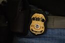FILE - A federal agent wears a U.S. Immigration and Customs Enforcement badge in New York, June 10, 2025.