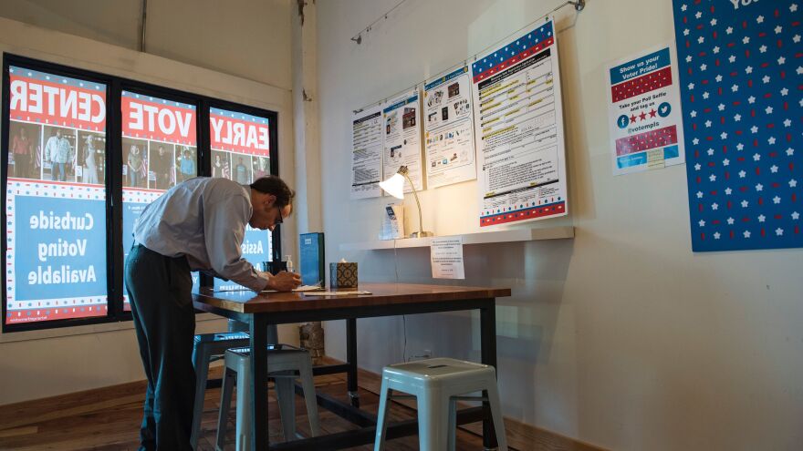 A man registers to vote at the Early Vote Center in Minneapolis on Oct. 5.