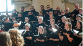 Charm City Sings chorus members, being conducted by Heidi Akerman, performing at a 2025 concert in Baltimore.