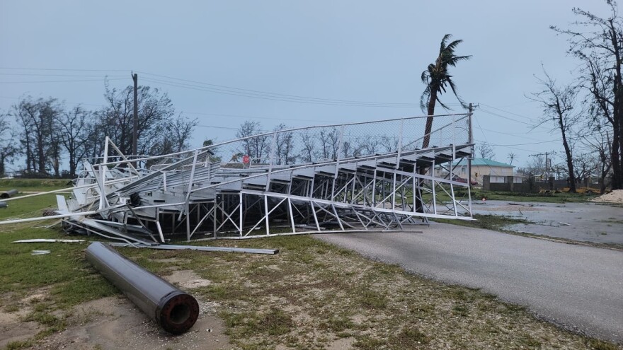 Debris covers the ground in Saipan on Wednesday, April 15, 2026, as a super typhoon with ferocious winds and relentless rains, shredded tin roofs and forced residents to take cover from flying tree limbs.