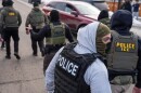 FILE - Federal agents conduct immigration enforcement operations Thursday, Feb. 5, 2026, in Minneapolis.