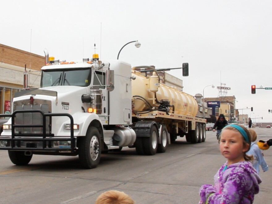 The oil industry stages events like this energy festival parade in downtown Williston in an effort to maintain good relations with the community. Industry rigs and trucks of every description roar by as drivers throw candy to the kids.