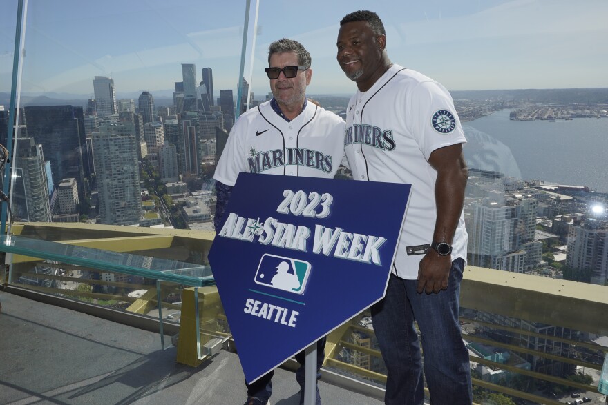 Seattle Mariners legends Edgar Martinez, left, and Ken Griffey Jr., right, pose for a photo before raising a flag for the 2023 MLB All-Star Game on the roof of the Space Needle, Thursday, Sept. 16, 2021, in Seattle. Earlier in the day, MLB Commissioner Rob Manfred announced that the Mariners will host the game at T-Mobile Park.