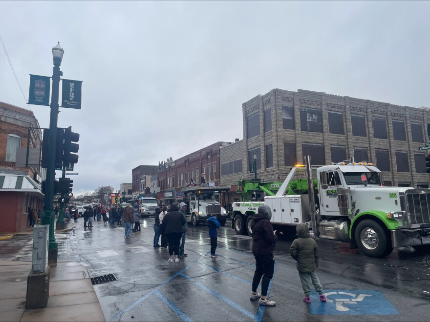 Trucks line up against the backdrop of an unused building downtown.