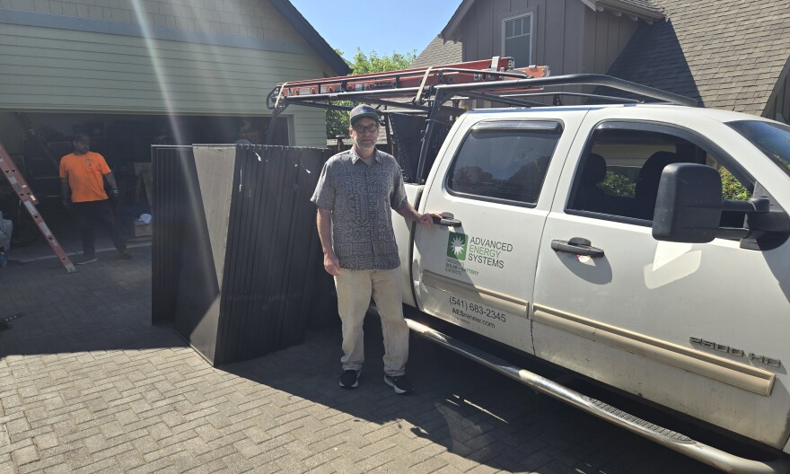 Advanced Energy Systems owner Eric Nill stands in front of a company truck at a job site.