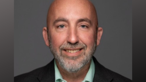 A photo portrait of a middle-aged man in a suit.