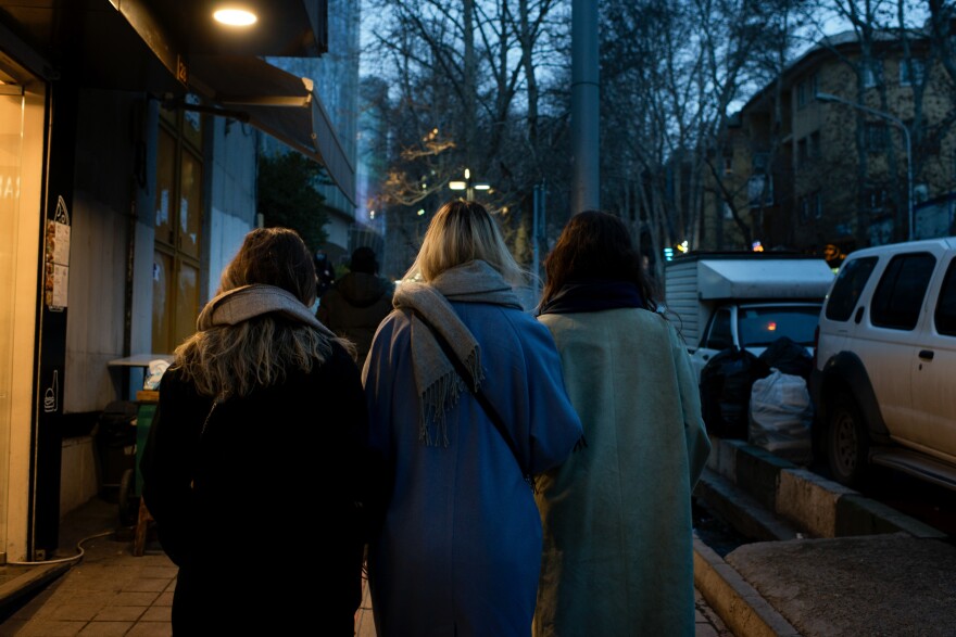 Women without headscarves stroll through Tehran's Tajrish Square in February 2023.