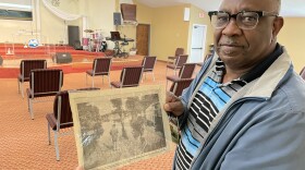 Pastor John Jones shows a newspaper article about the 2011 flooding of his church, Bethesda Word of Life Christian Center, near the Wolf River in north Memphis. 