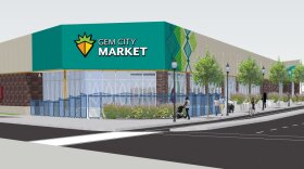 A rendering of the Gem City Market, a building on a corner with a green painted front, trees, people walking, and a bus coming down the road.