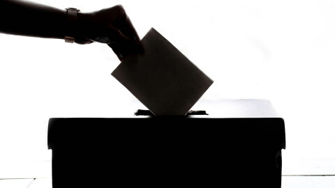 Ballot box with vote being cast image
