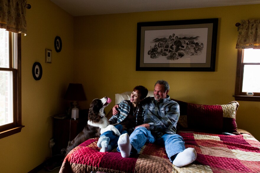 Cawthorn and her husband, Tucker, play with their dog, Oliver, in their bedroom.