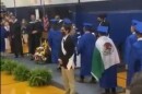 In a video posted on Twitter, a high school student is shown with the Mexican flag draped over his shoulders as he approaches the stage at graduation. A few seconds later, he is not given his diploma.