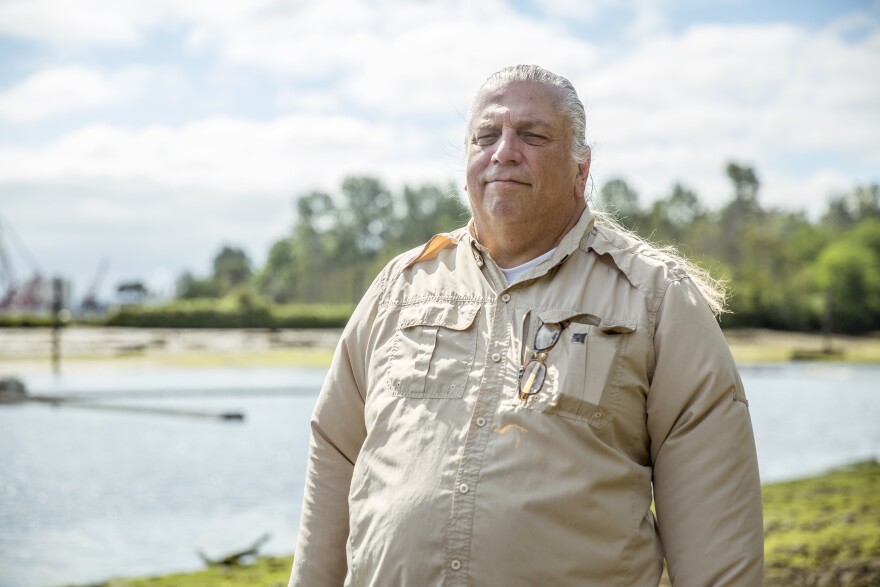 James Rasmussen, director of the Duwamish River Cleanup Coalition and member of the Duwamish Tribe, stands on the bank of the river inside Seattle’s Herring’s House Park. Having spent 30 years cleaning and restoring the river, he says the river is part of