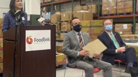 Foodlink's Julia Tedesco speaks in support of the Child Poverty Reduction Act. Lead sponsor Assemblyman Harry Bronson (center) and Dr. Pat Brophy of Golisano Children’s Hospital and American Academy of Pediatrics to the right CREDIT JAMES BROWN / WXXI NEWS