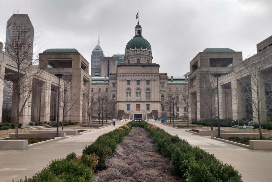 Indiana Statehouse flanked by the Government Center on overcast day.