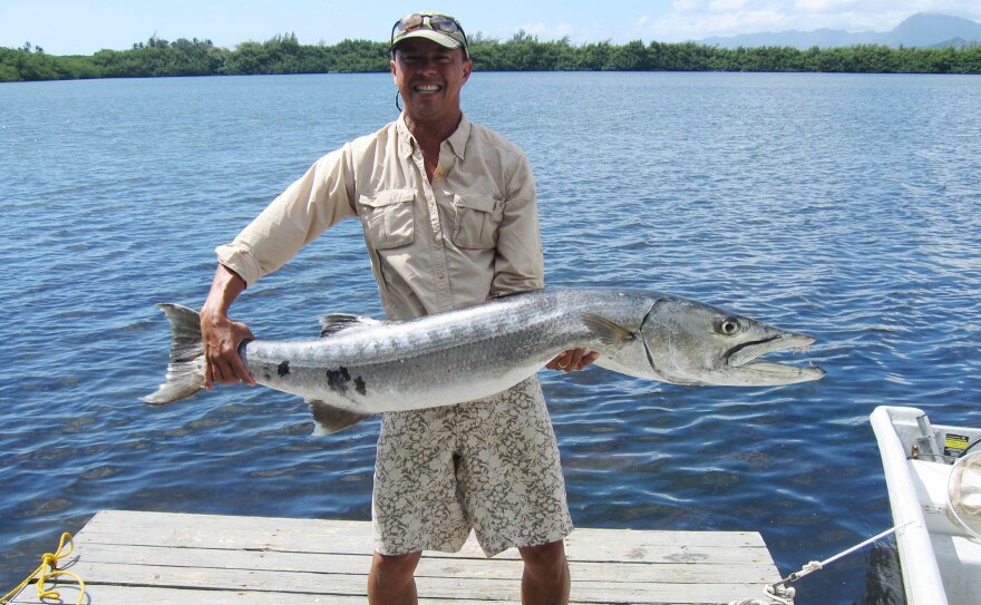 FILE - Posing with a barracuda.