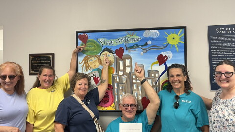 Members of the Woodsdale and Trenton Environmental Resistance group pose for a picture in the city building after submitting a petition seeking to change the city charter to prohibit the construction of data centers over 25 megawatts.