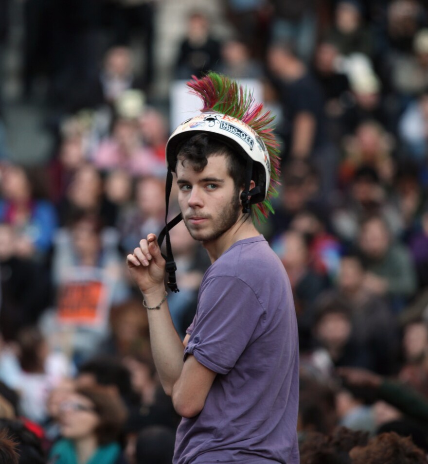 <p>A protester stands outside St Paul's Cathedral in London. </p>