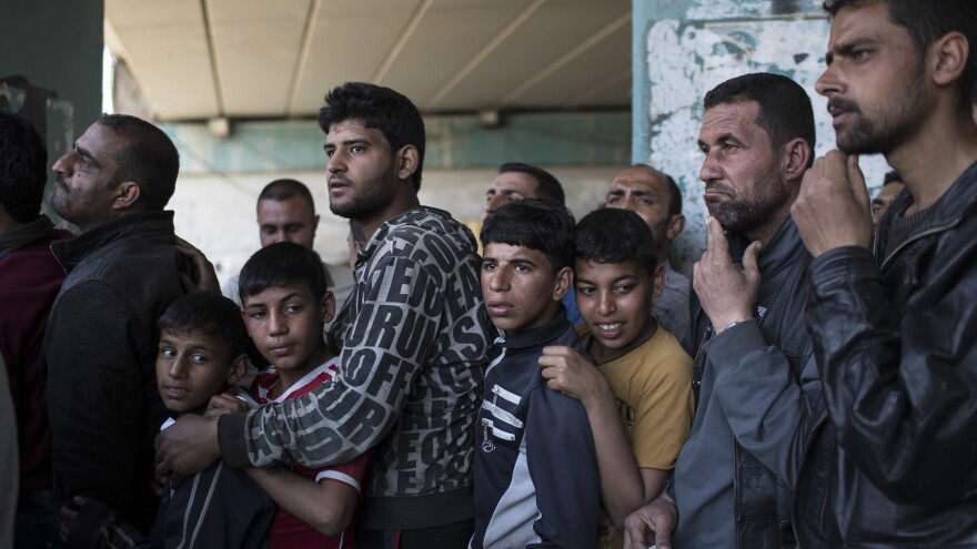 Iraqis line up for food distribution on Wednesday in West Mosul.